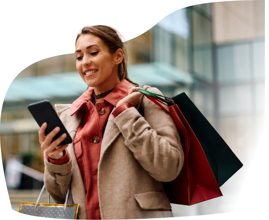 Woman checking rewards on her phone while shopping